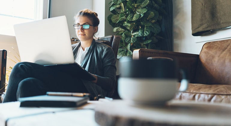 Woman researching at home on computer