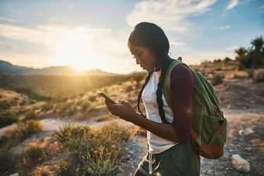 woman-hiking-checking-smartphone